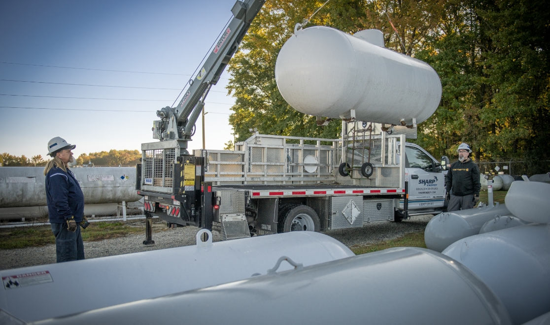 why-choose_callout2 Sharp Energy crew delivering a propane tank
