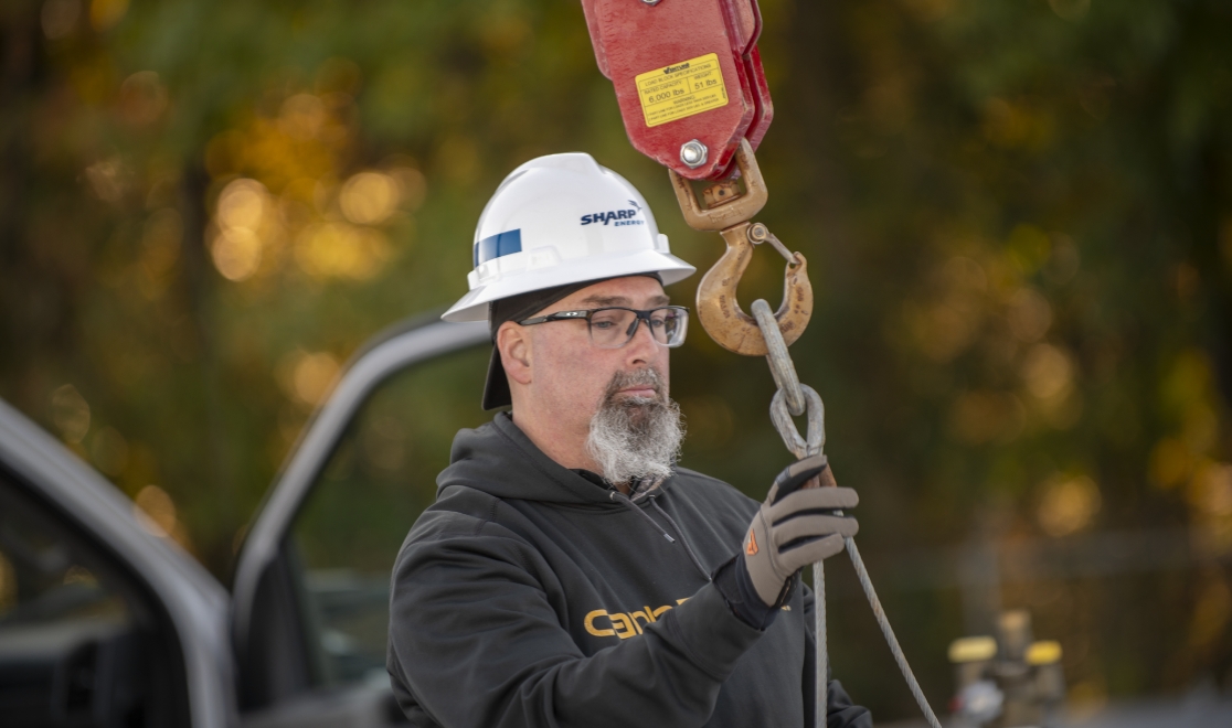 why-choose_callout6 Sharp Energy technician in a hard hat